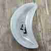 Black triangle earrings with shell, in a bowl
