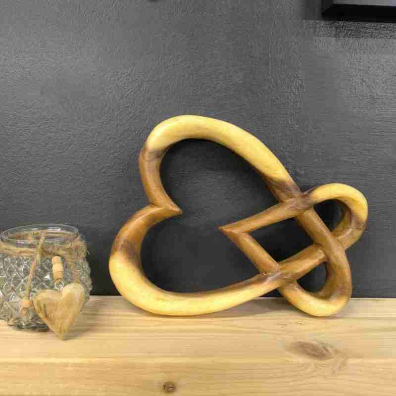 Linked hearts wood carving stood on its side Linked hearts wood carving stood on its side